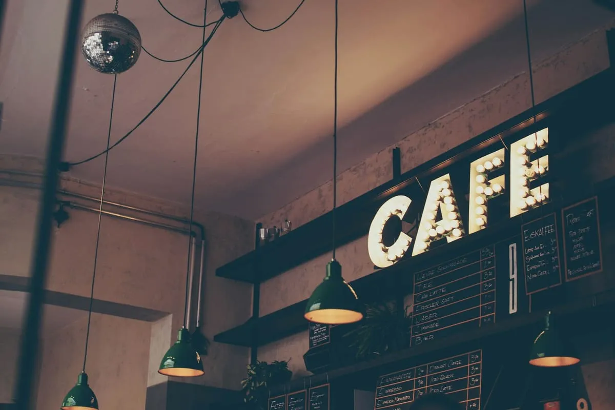 A neon café sign above an espresso bar