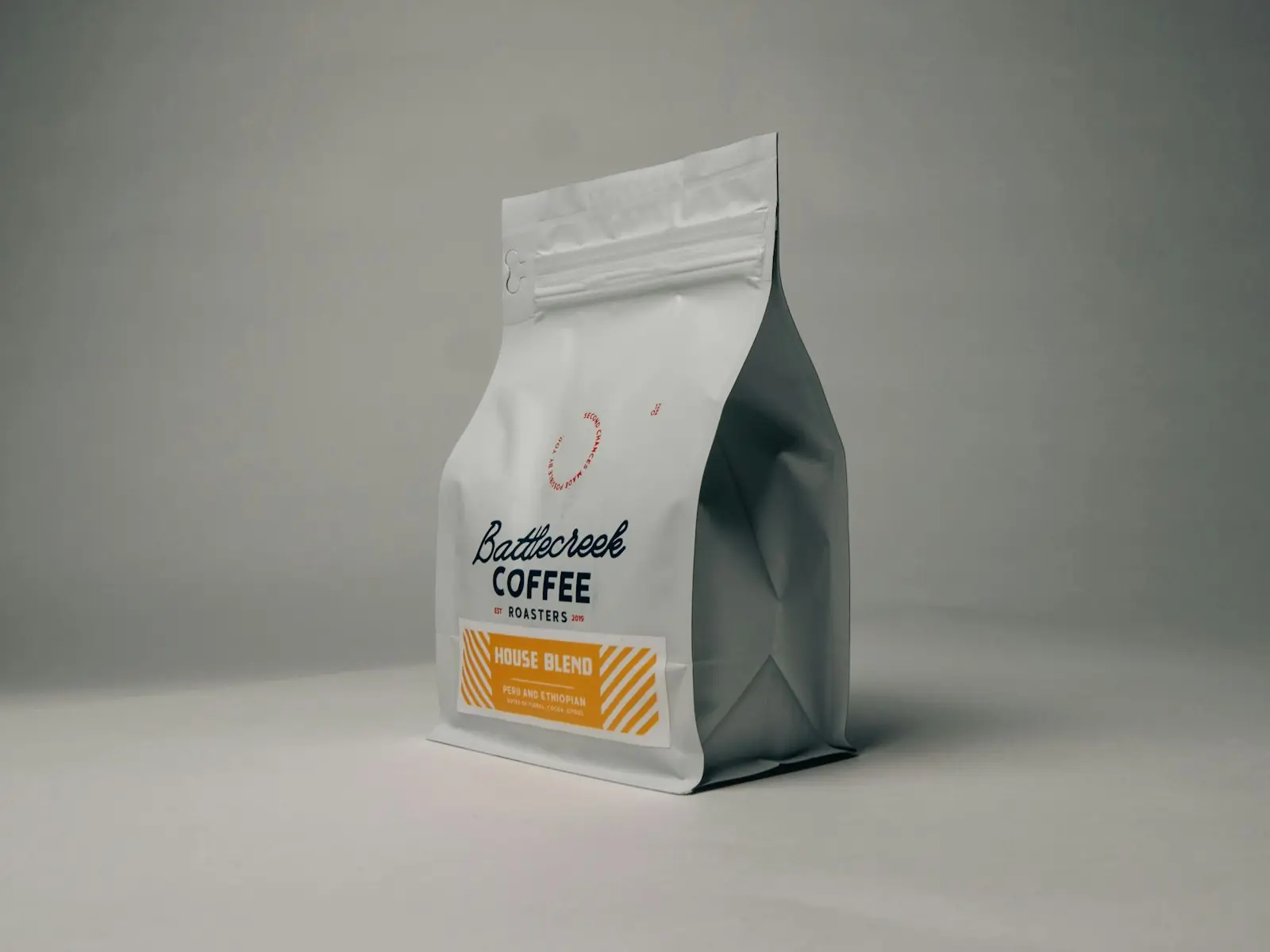 A bag of roasted specialty coffee on a grey table