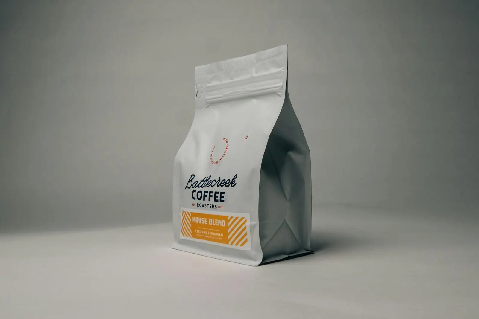 A bag of roasted specialty coffee on a grey table