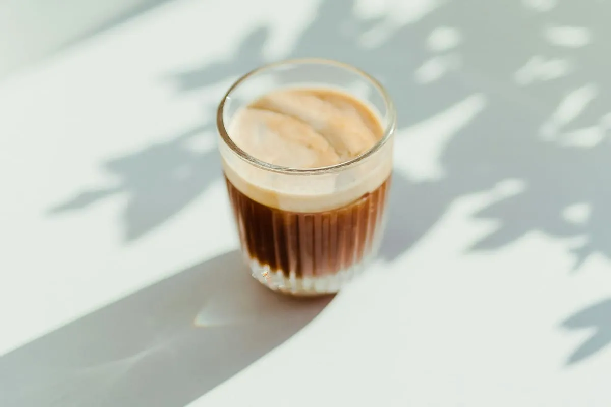 A glass of cortado on a table