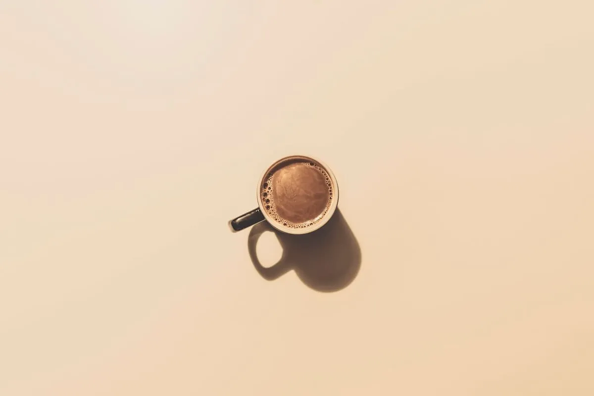 A small cup of coffee on a pale background